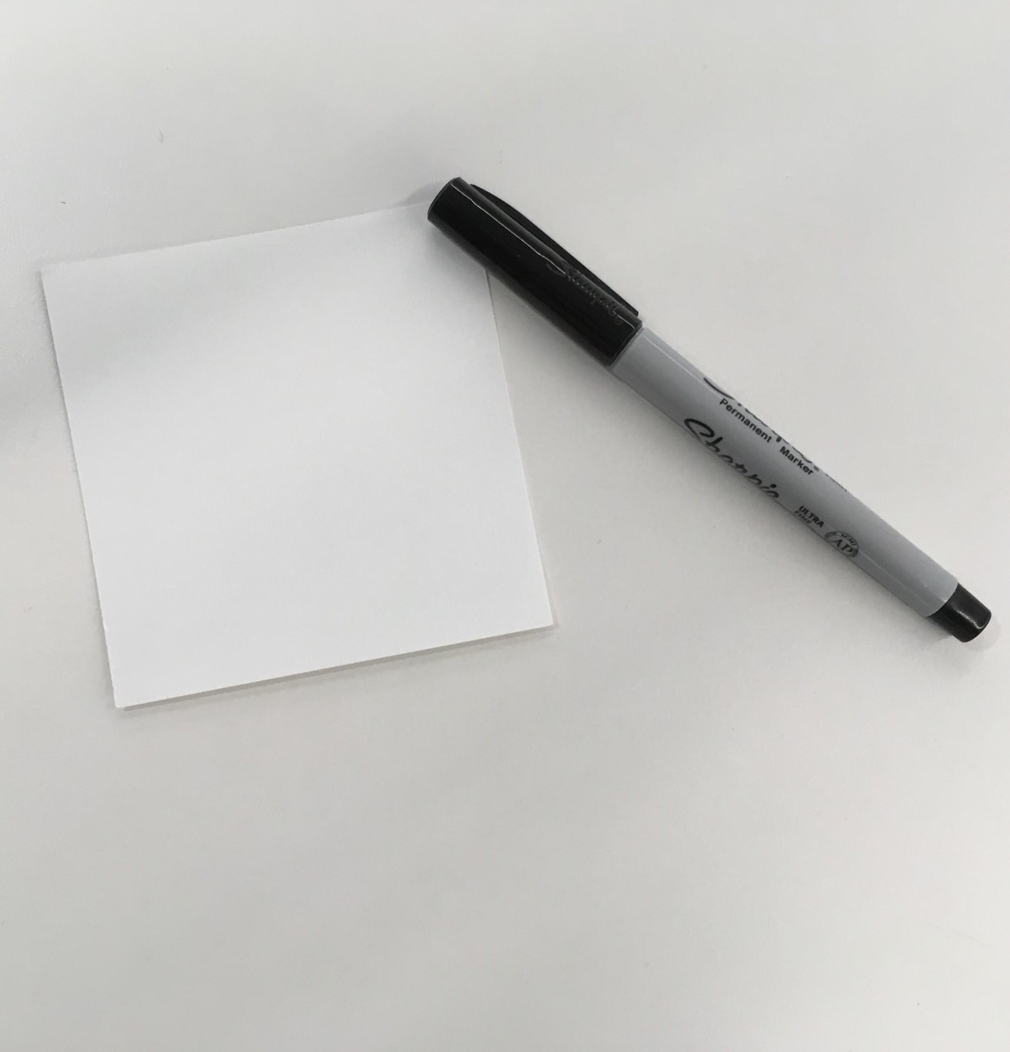 Blank square of paper with marker.